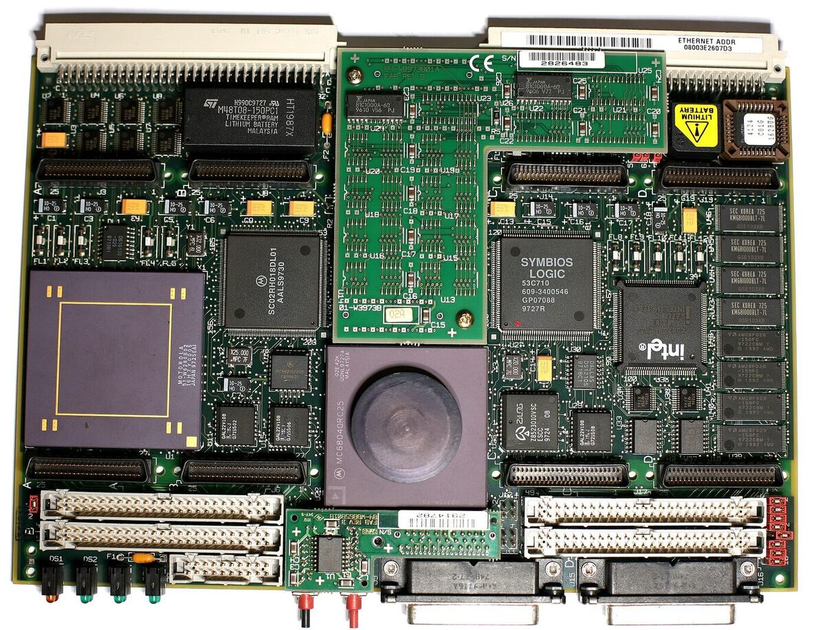 Top view of a green circuit board densely packed with chips, including a large square MC68040 processor, memory modules, a SCSI controller and rows of connectors along two edges.