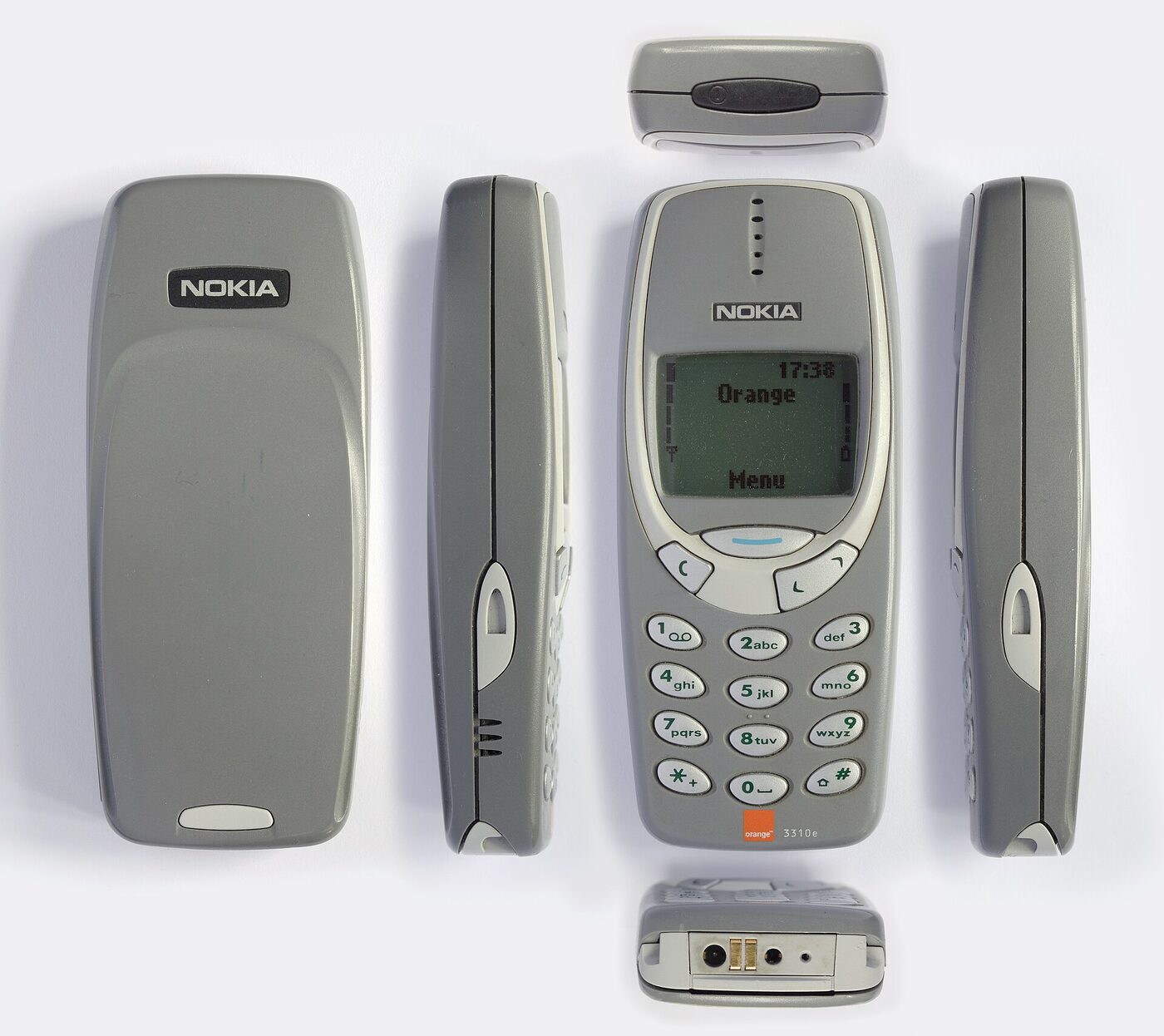 Composite photograph showing the front, back, sides, top and base of a grey candybar mobile telephone with a small monochrome screen above a numeric keypad