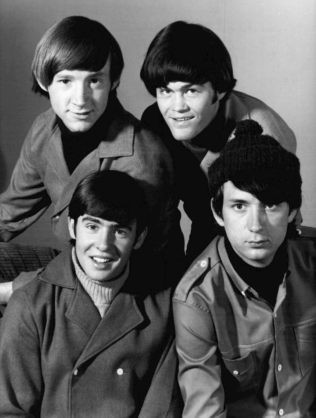 Black-and-white publicity photograph of the four members of the 1960s pop group the Monkees posed together.