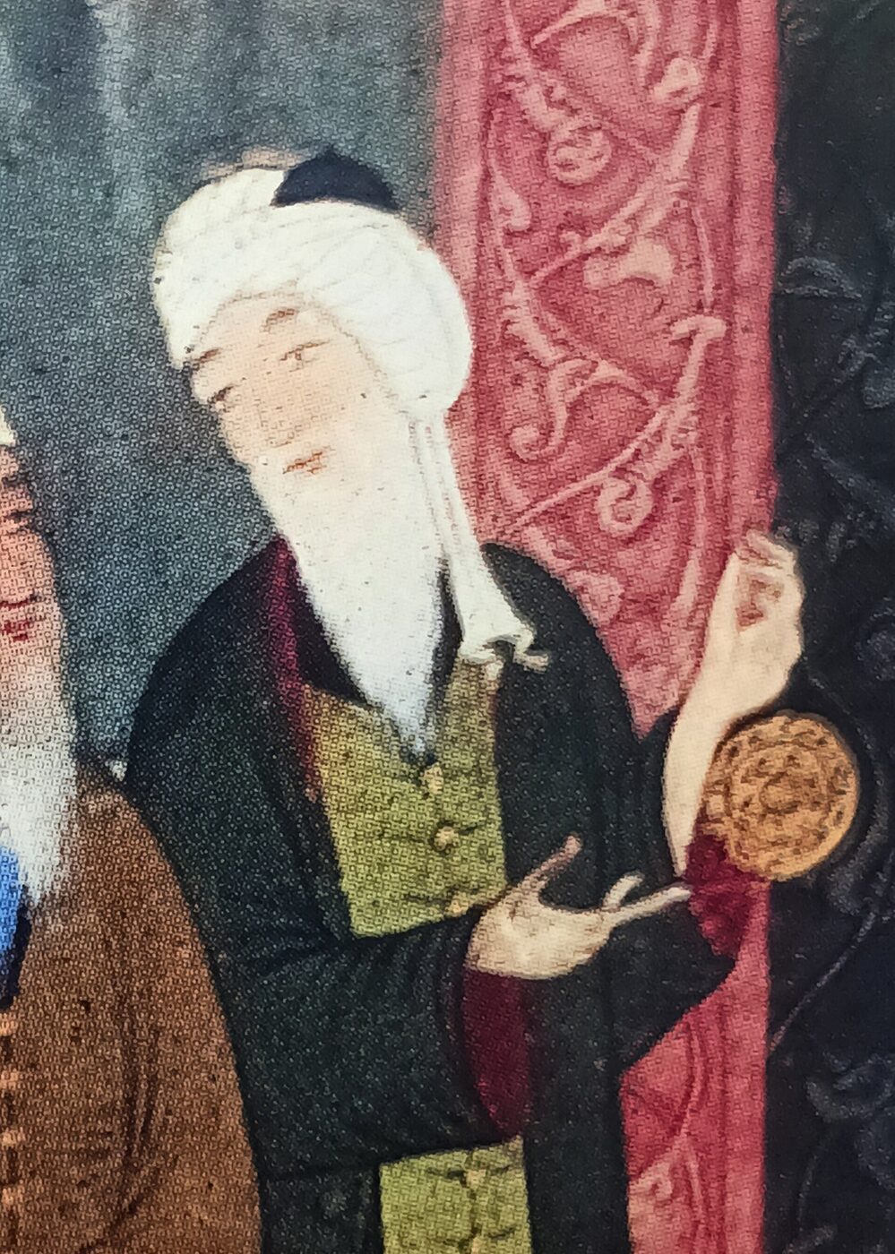 Detail of a Persian miniature: a white-bearded man in a large white turban and dark robe over a green tunic holds up a small gilt astrolabe against a patterned pink hanging.