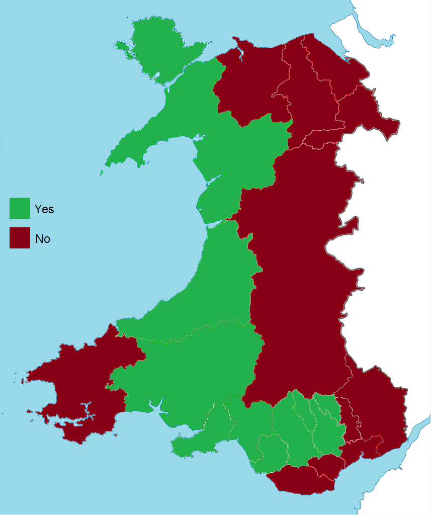 Map of Wales with counties coloured green for a Yes majority and dark red for a No majority, the two roughly balanced between west and east.