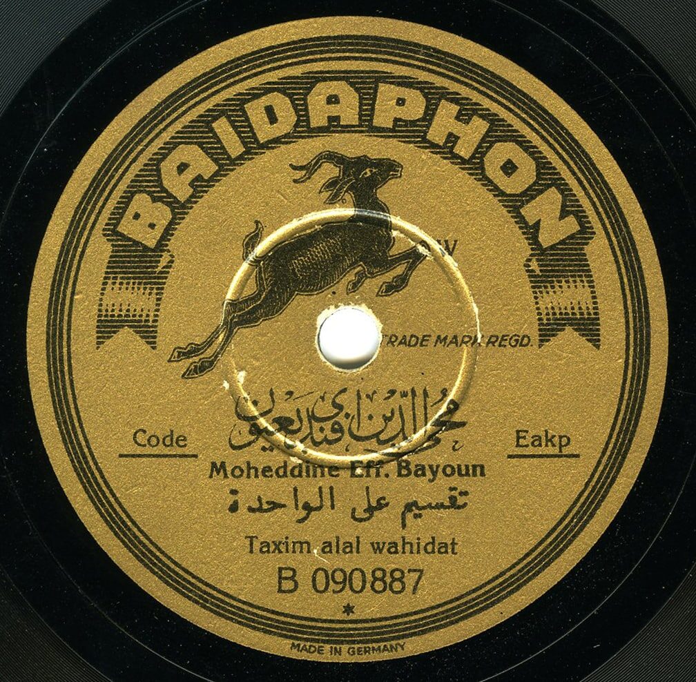 A gold and black 78 rpm gramophone record label carrying the word BAIDAPHON around the top, a leaping gazelle emblem in the centre, then a line of Arabic script above the roman transliteration Moheddine Eff. Bayoun, a second Arabic line above the words Taxim alal wahidat, the number B 090887, and MADE IN GERMANY at the foot.