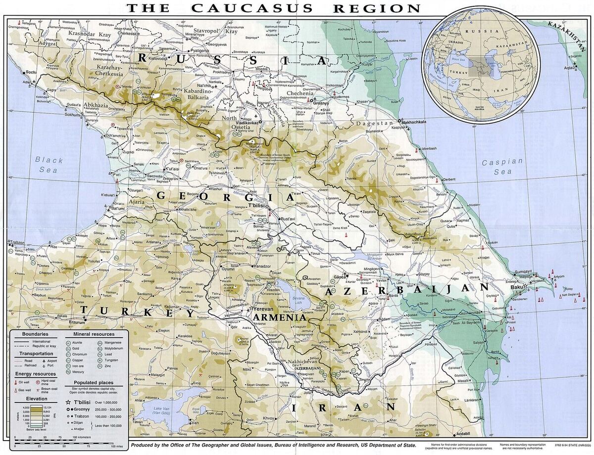 Shaded-relief map titled The Caucasus Region, showing Georgia, Armenia, Azerbaijan, southern Russia and parts of Turkey and Iran, with international and republic boundaries, capitals and towns labelled in English, and a legend for elevation, transport and mineral resources.