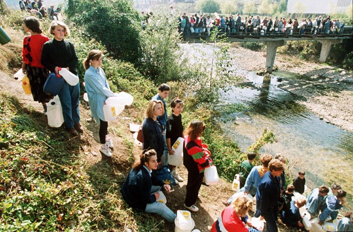 Residents of besieged Sarajevo queuing with containers to collect water during the war in Bosnia, 1992.