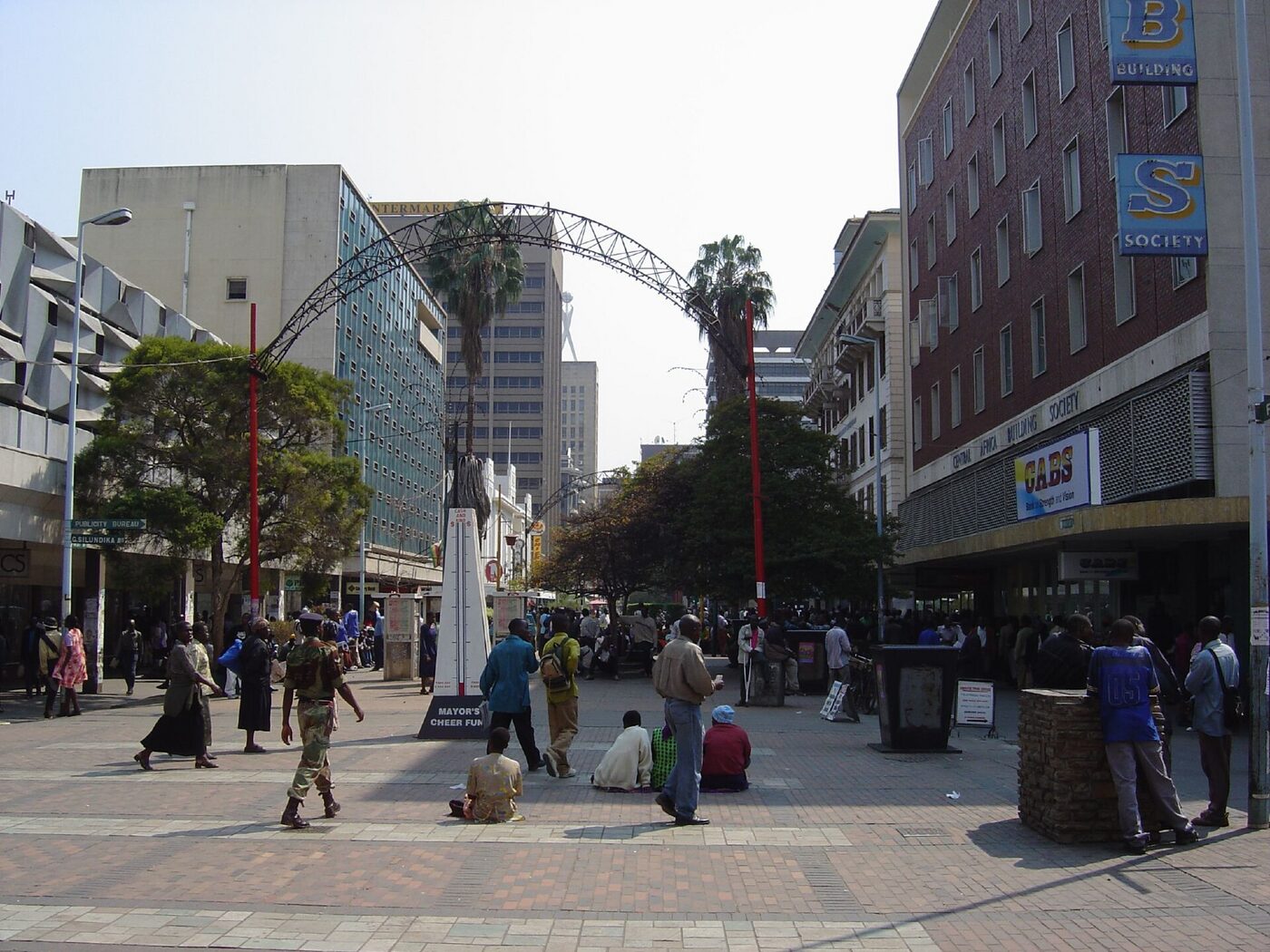 Pedestrians on First Street, a tree-lined shopping street in central Harare, photographed in 2003.